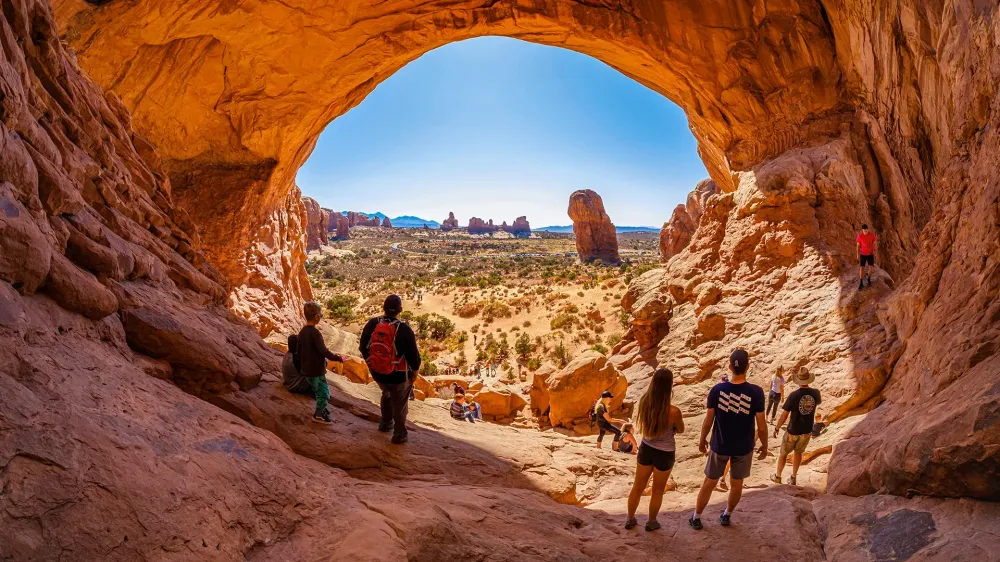 Moab, Utah USA - October 19, 2019: Tourists enjoying the natural beauty of the Double Arch in Arches National Park.